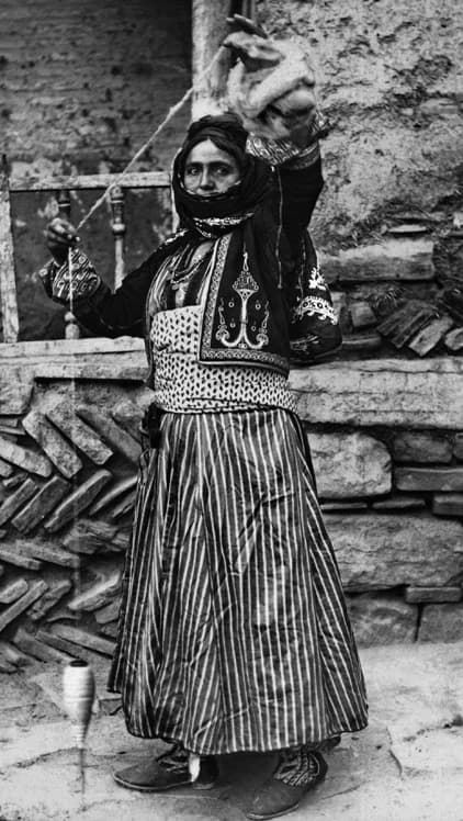 Nestorian (Assyrian) woman spinning wool with a hand spindle