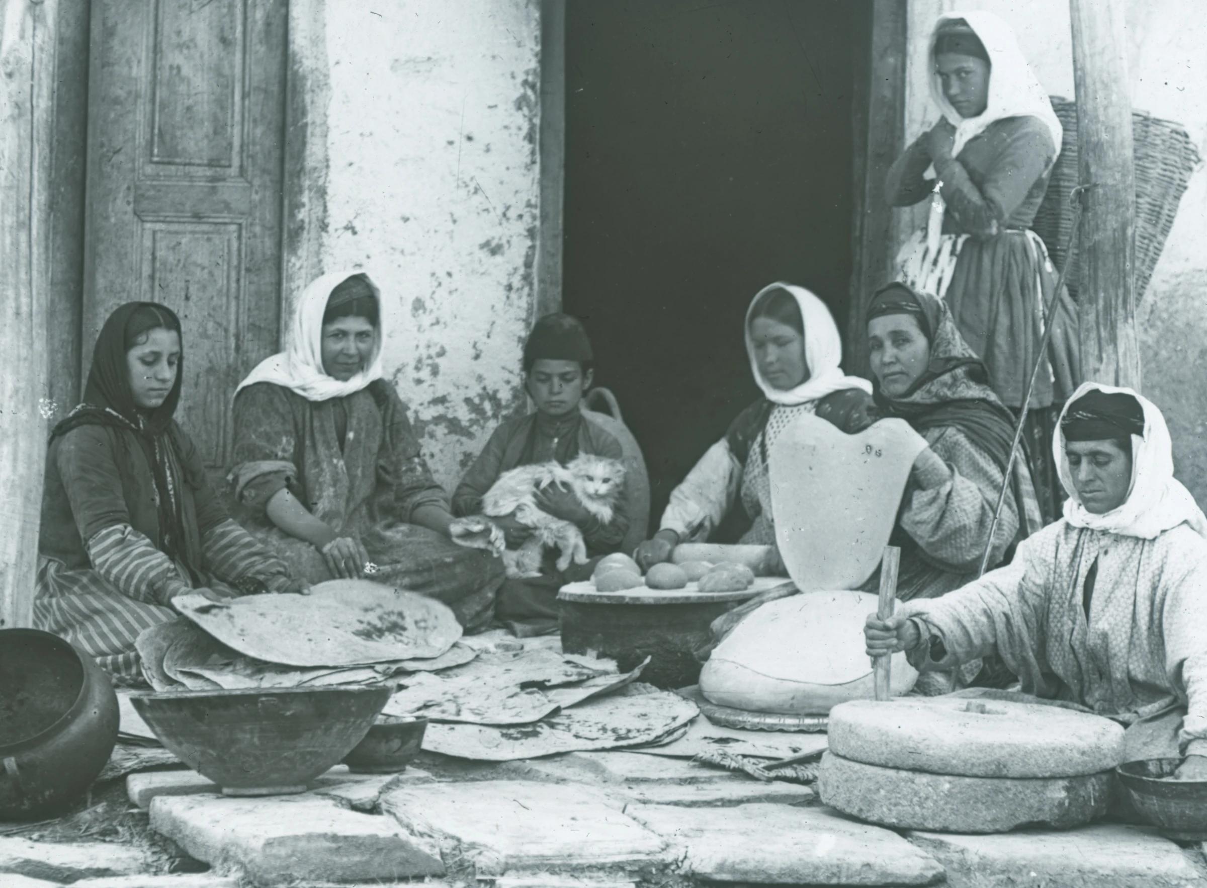 Nestorian (Assyrian) women grinding grain and baking bread