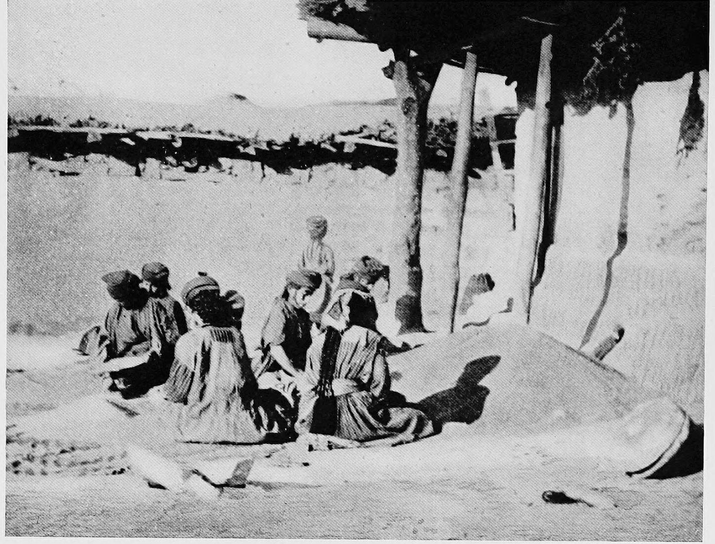 Syrian (Assyrian) women cleaning grain on the roofs at Bibaydi