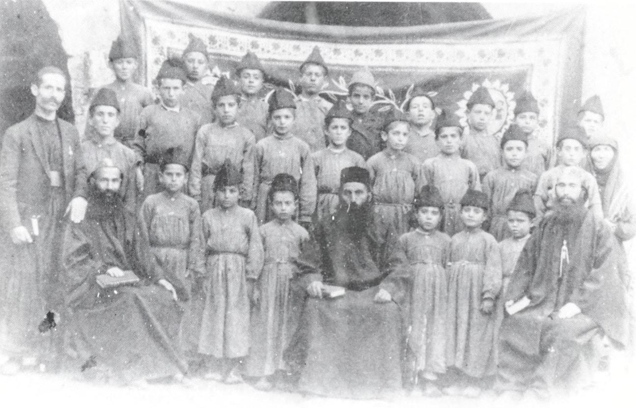 Monk Hanna Dolabani with orphaned students at Deyrulzafaran, 1918
