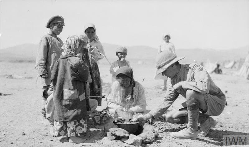Jilu Assyrian refugees cooking with a British soldier, 1918
