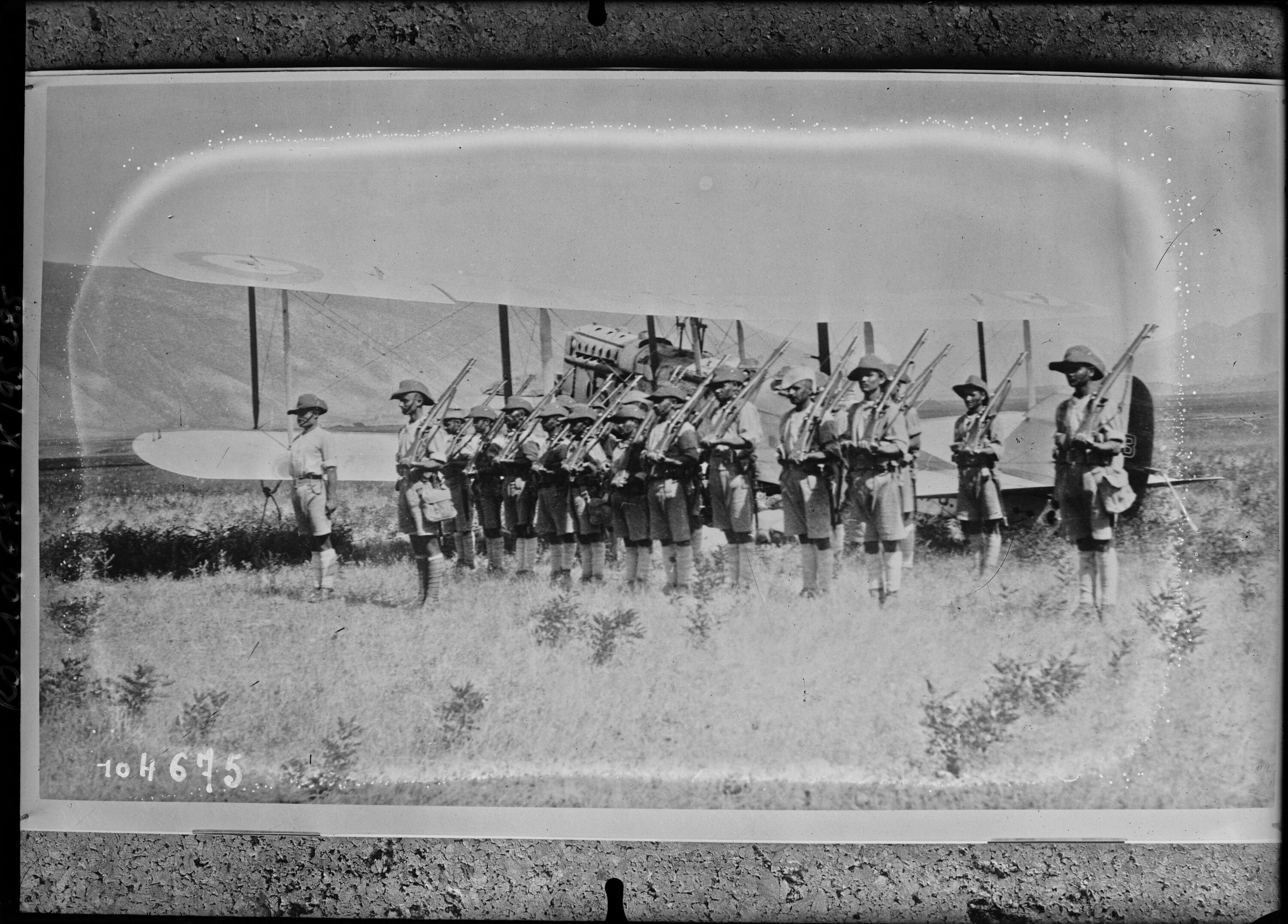 Assyrian troops in front of a British bomber in Iraq