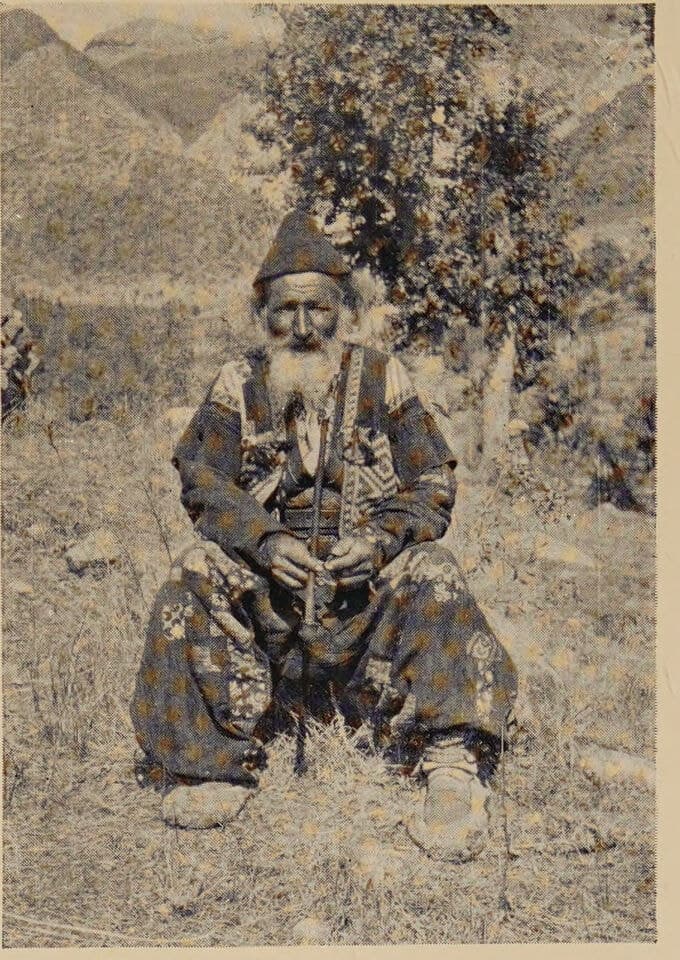An Assyrian priest in a peaked cap and rishiki shoes