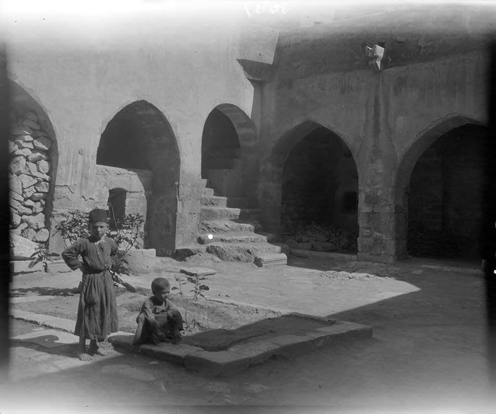 Two boys in the cloister of the church of Mar Ahudani, Mosul, 1909