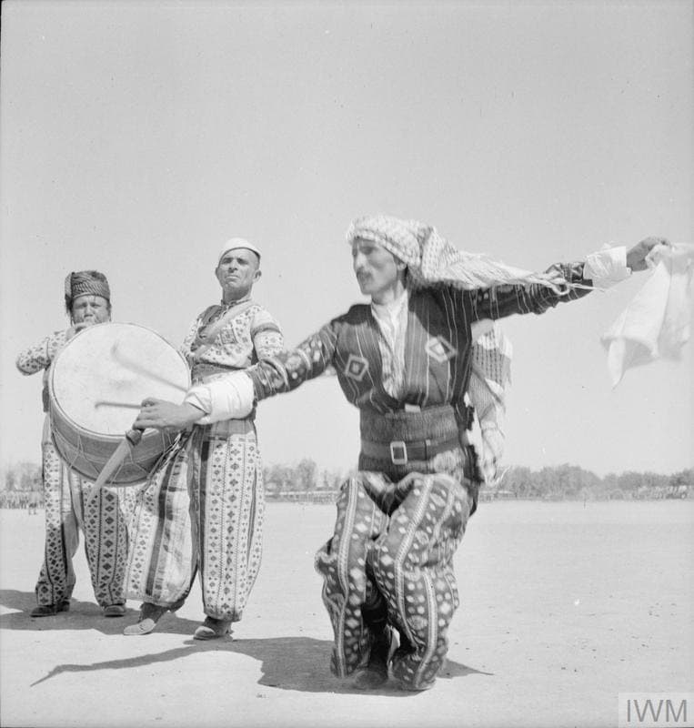 Dancer and drummers in national dress, likely the Assyrian khigga, Iraq, 1942