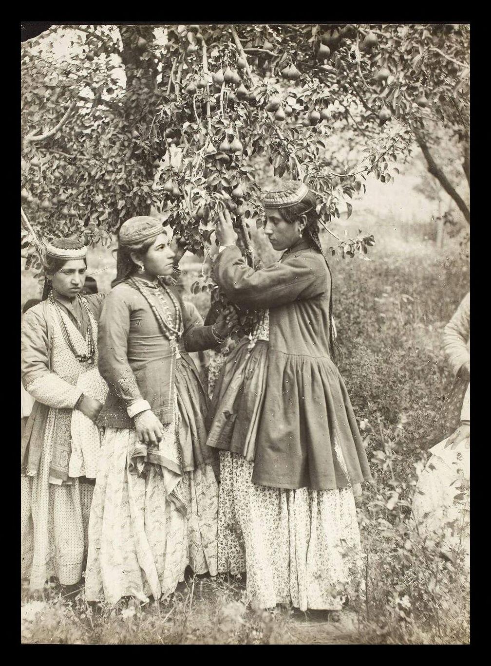 Assyrian girls in traditional dress in a garden, Urmia