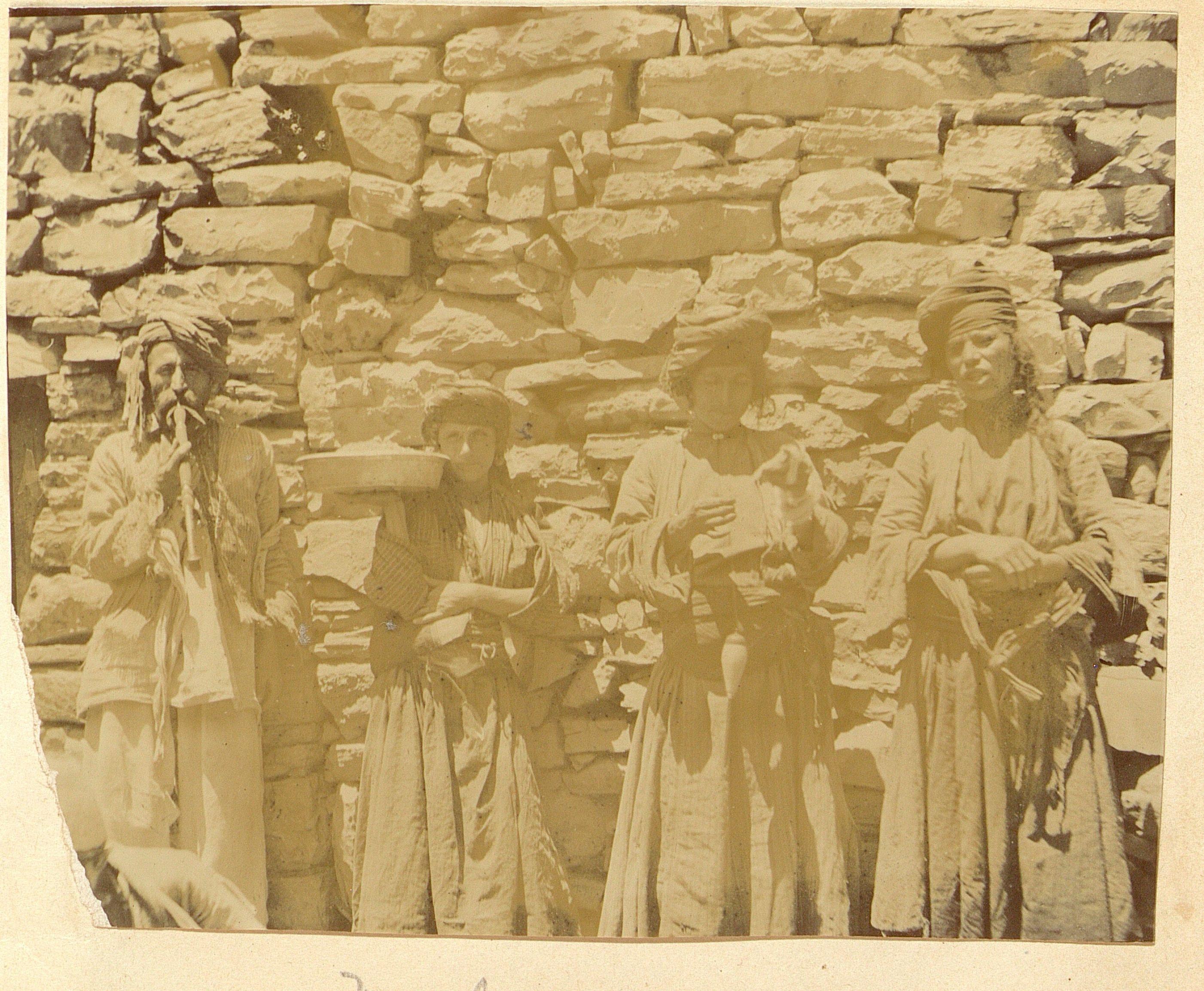 Mountain Nestorians in front of a stone wall