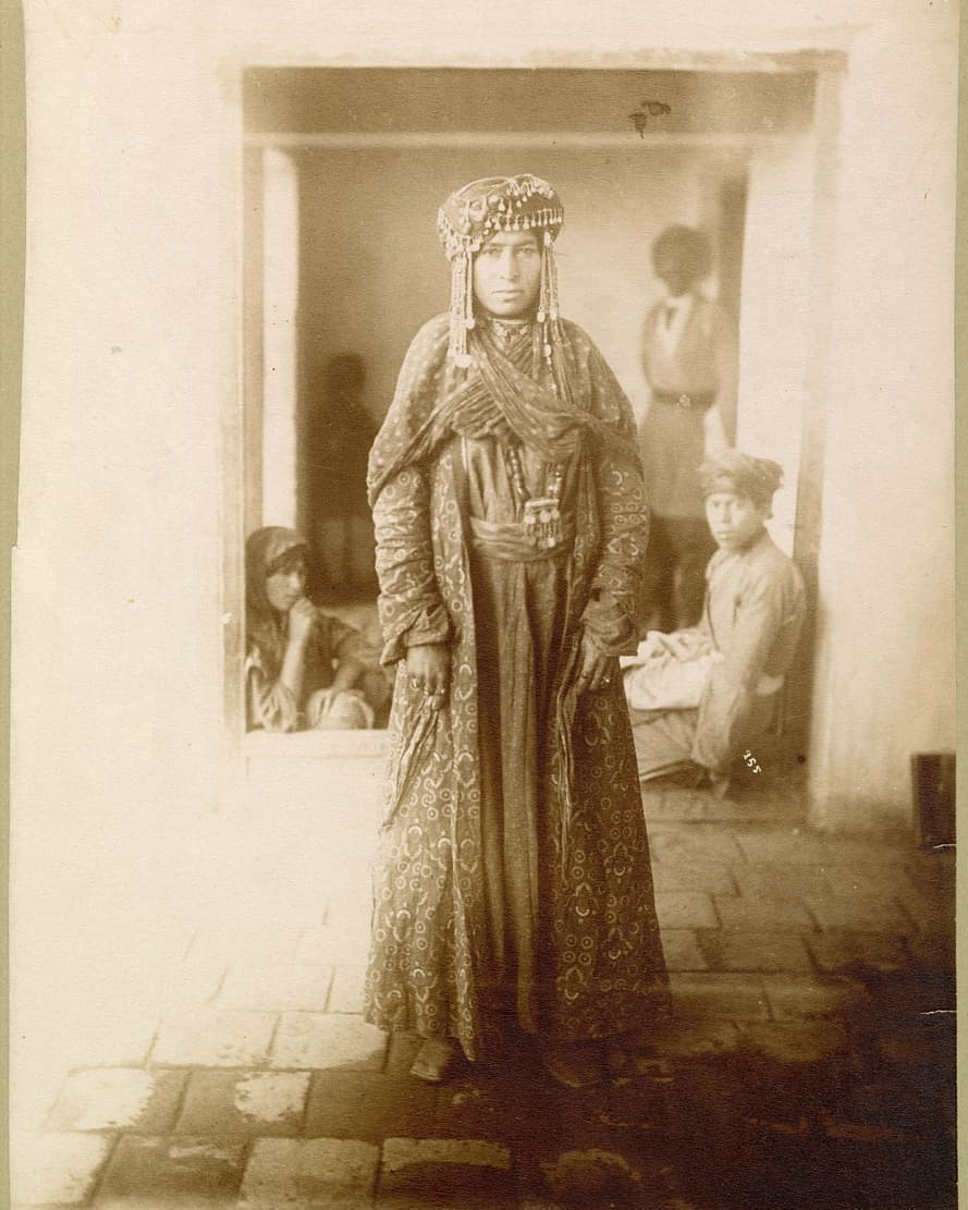 Chaldean woman in patterned dress and jewelled headdress, Salamas