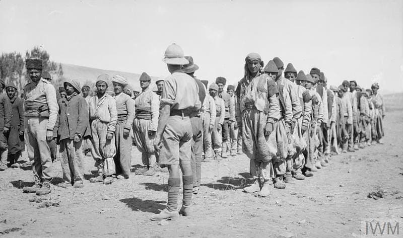 Jilu Assyrian men lined up before a British officer, Hamadan