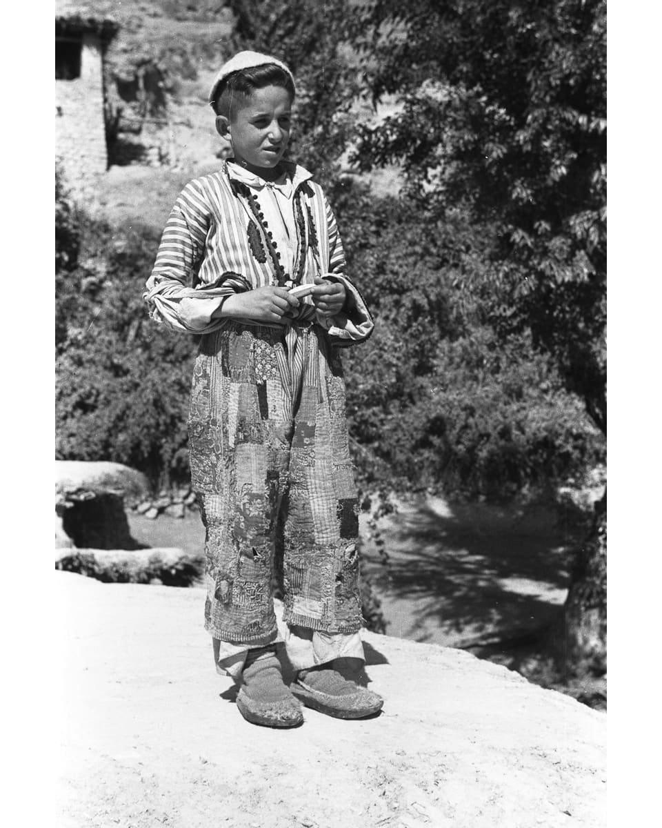 Assyrian boy in patched trousers