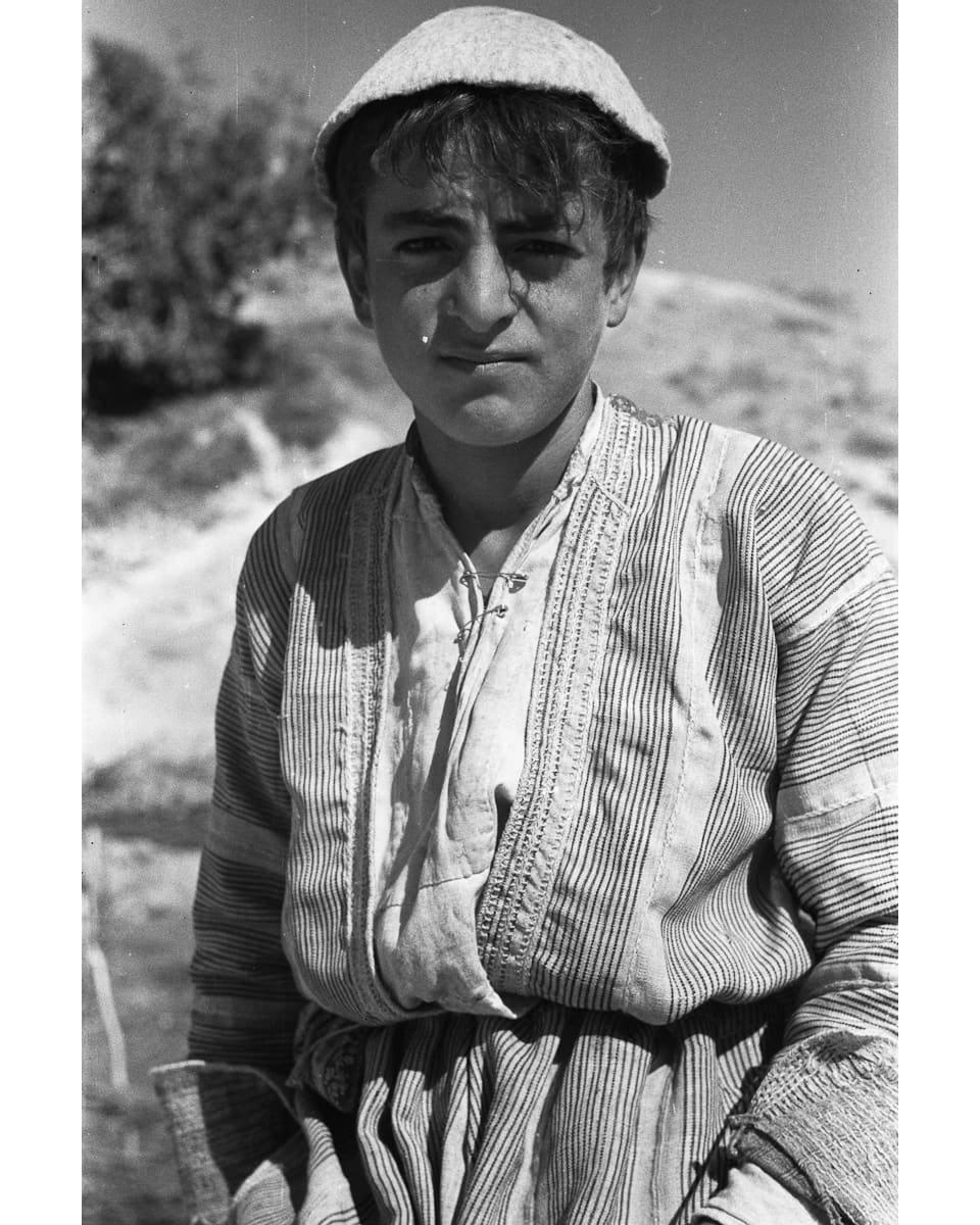 Assyrian boy in a striped tunic