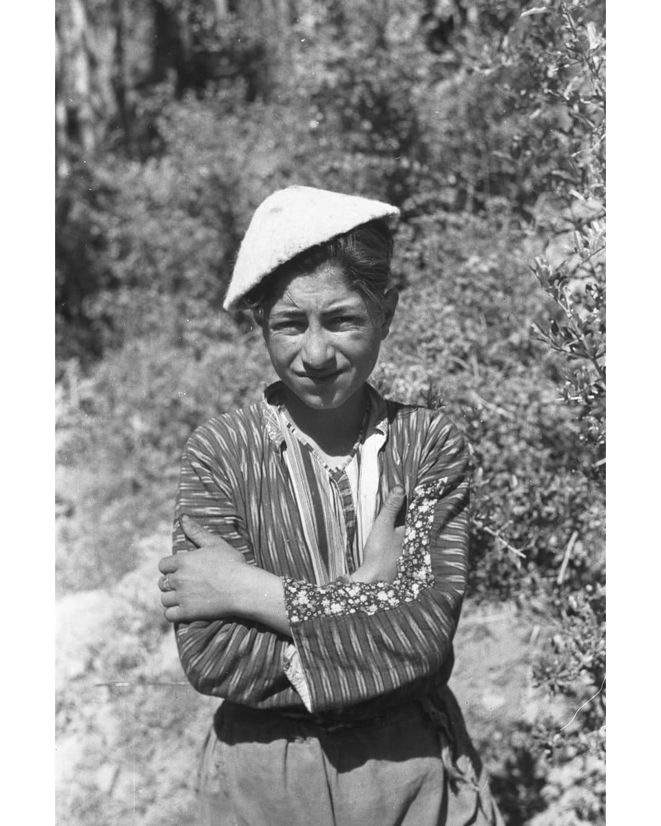 Assyrian boy with folded arms