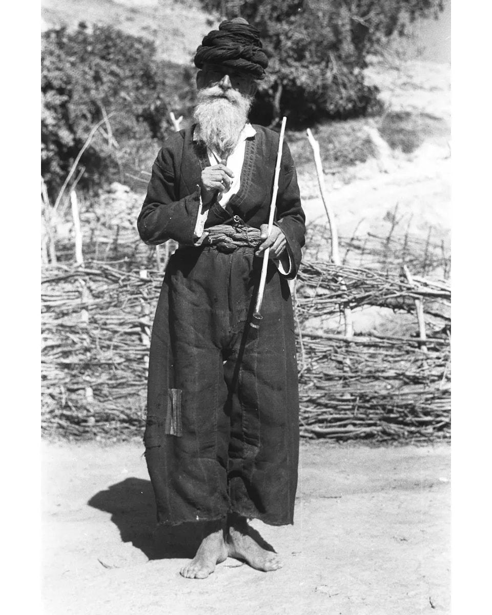 Old Assyrian man with a stick