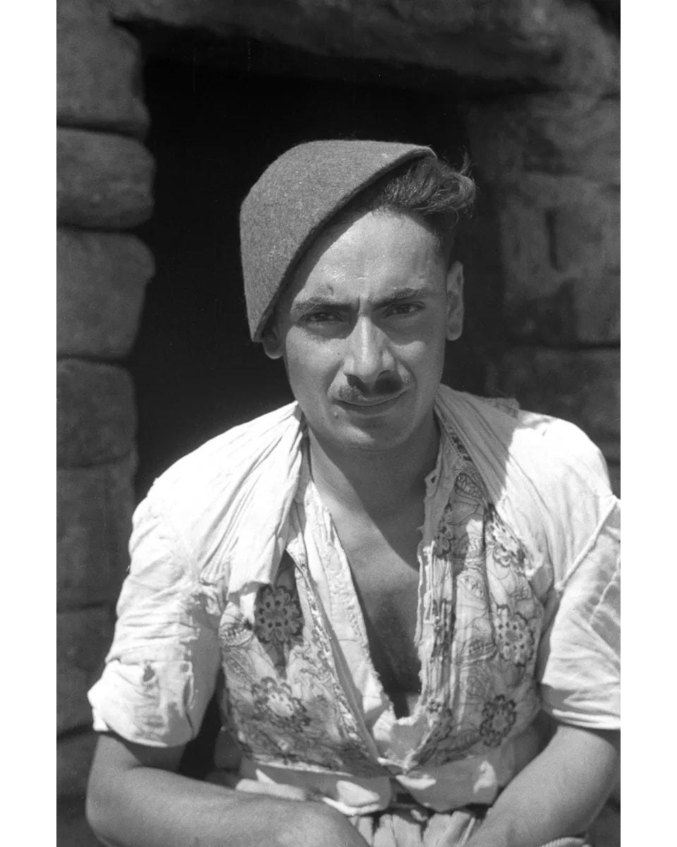Seated Assyrian man in a felt hat
