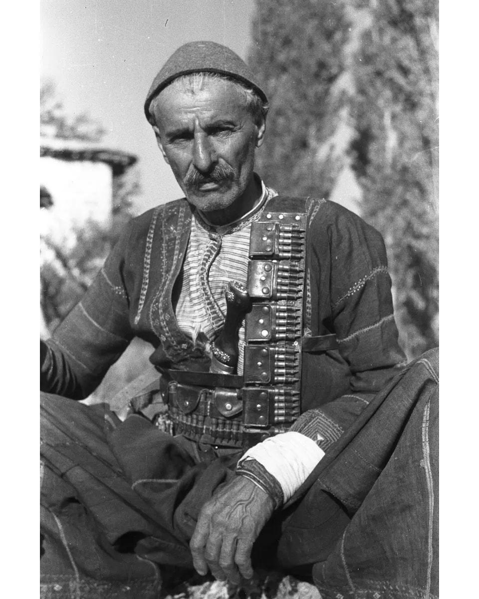 Jajee d'Be-Naseemo seated with cartridge belts