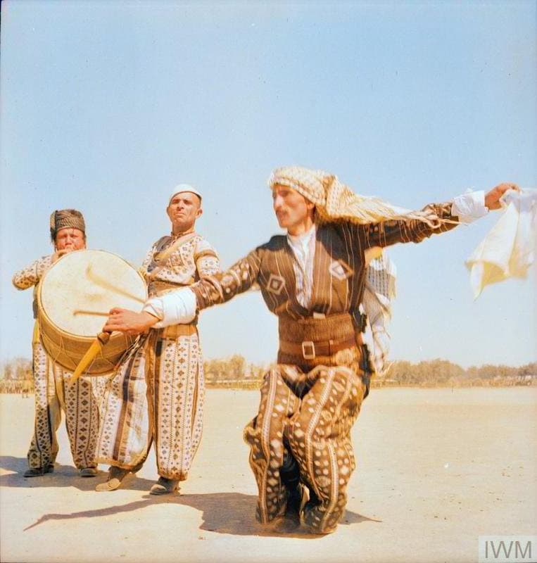 Dancer and drummers in national dress, likely the Assyrian khigga, Iraq, 1942