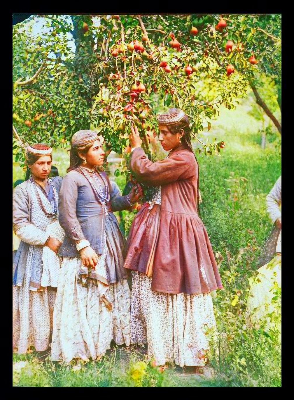 Assyrian girls in traditional dress in a garden, Urmia