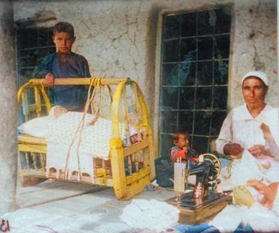 Assyrian family at home with a sewing machine, Armenia