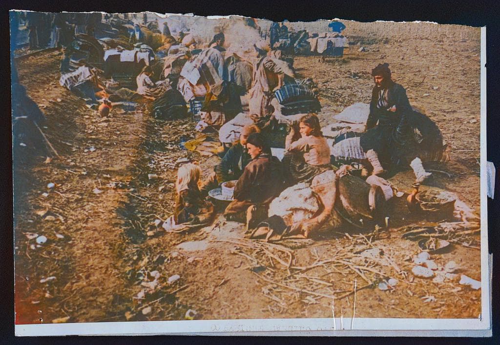 Assyrian refugees from North Persia waiting by a railway in Mesopotamia